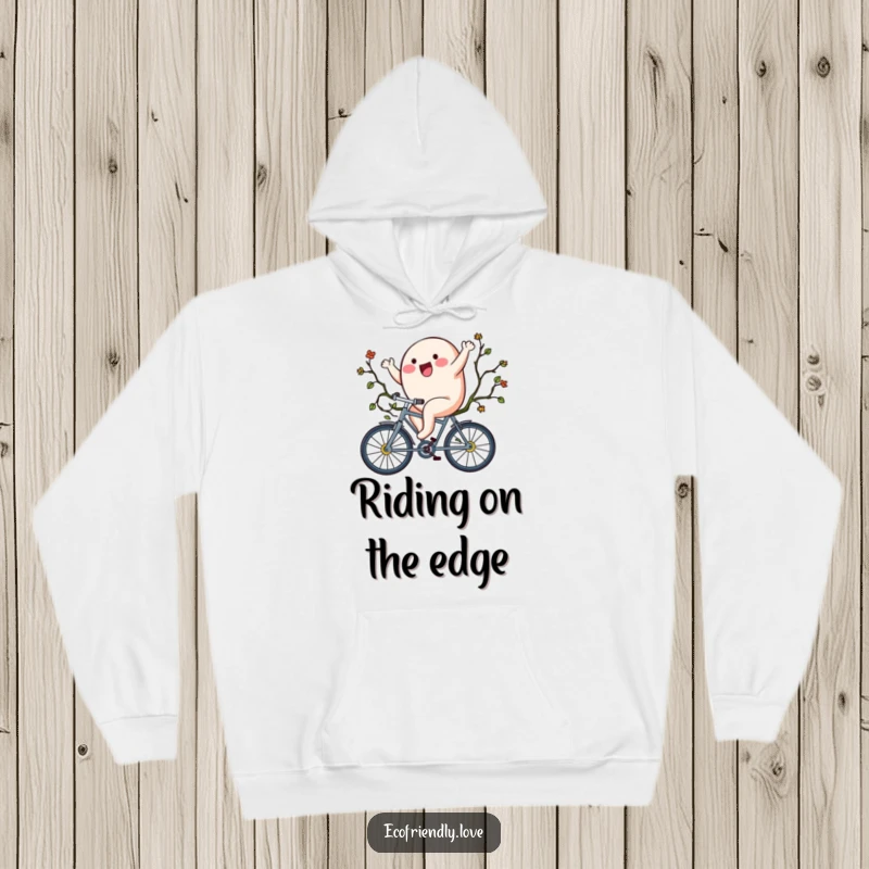 Funny hoodie showcasing a delighted blob character cycling on a unique bicycle crafted from lush vines.