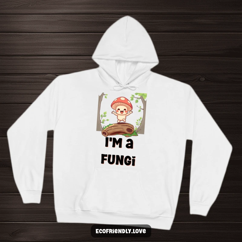 Funny hoodie featuring a happy mushroom character bouncing on a mossy log, offering warm and whimsical comfort.