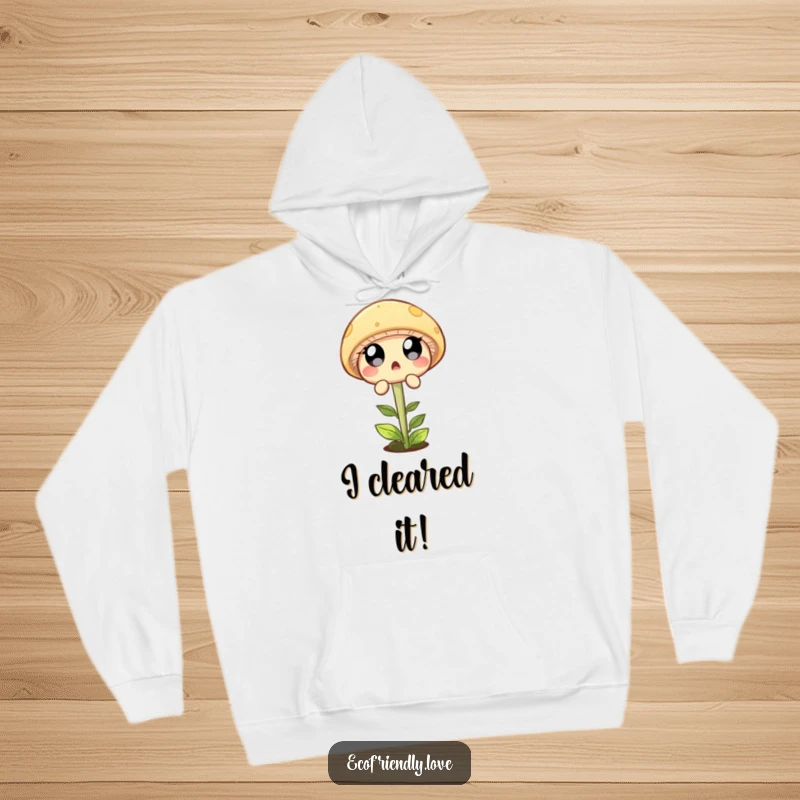 Funny hoodie with a surprised mushroom character in mid-air, dramatically leaping over a tiny sprout in a humorous scene.