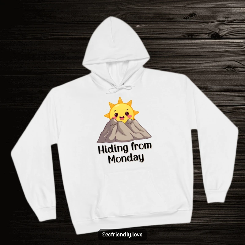 Funny hoodie with a surprised sun character peeking from behind a smiling mountain, perfect for cozy adventures and cheerful days.