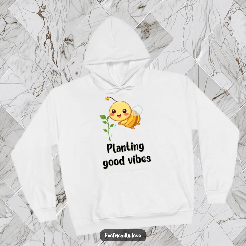 Funny hoodie depicting a happy bee in mid-flight, holding a delicate plant sprout, bringing a sense of new beginnings.