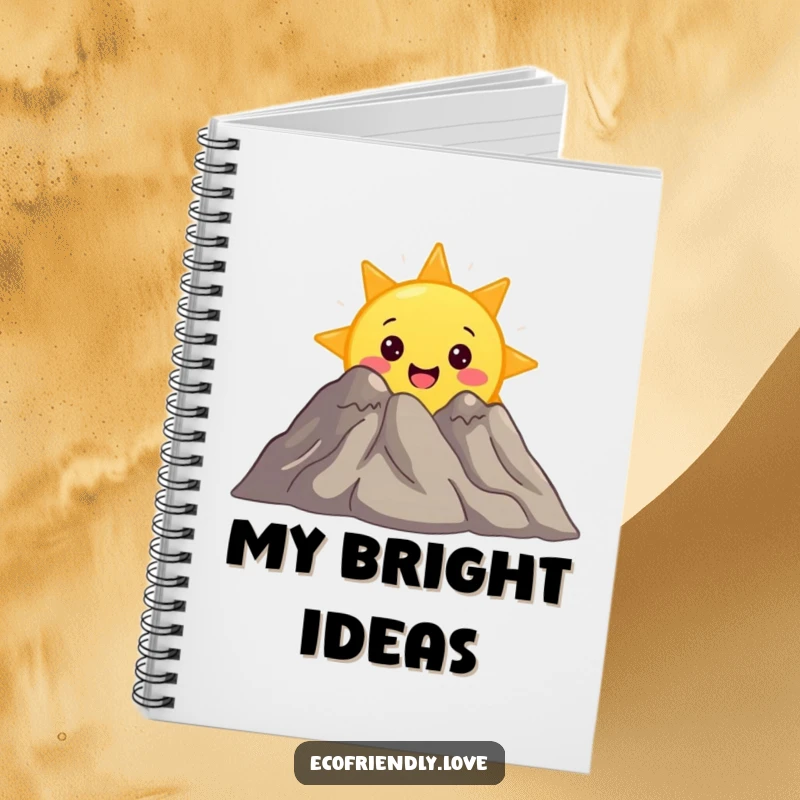 Funny notebook with a surprised sun character peeking from behind a smiling mountain, perfect for journaling adventures and sunny thoughts.