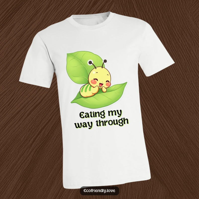 Funny Caterpillar T-Shirt featuring a giddy character joyfully munching on a big green leaf, radiating pure delight.