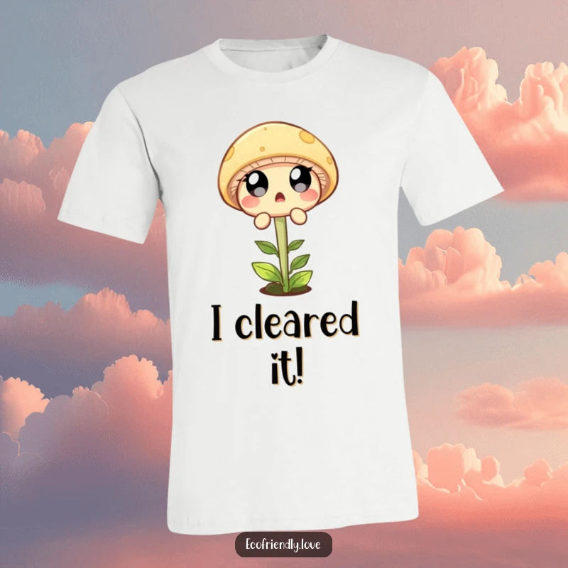 Funny T-shirt showing a round mushroom character with wide, surprised eyes joyfully leaping over a small green sprout.